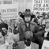 [TITLE: American country singer and songwriter Johnny Paycheck (1938 - 2003) (C) holds a teamsters union sign while joining a group of striking bookbinders, 1977. (Photo by Hulton Archive/Getty Images)] [AUTHOR: Hulton Archive] [SOURCE: Getty Images]